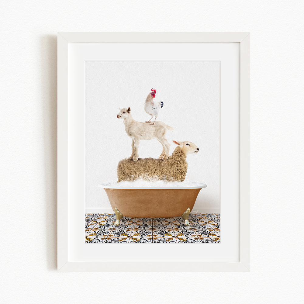A framed image depicting a goat standing on a sheep's back while a rooster stands on top of a sheep in a bathtub.
