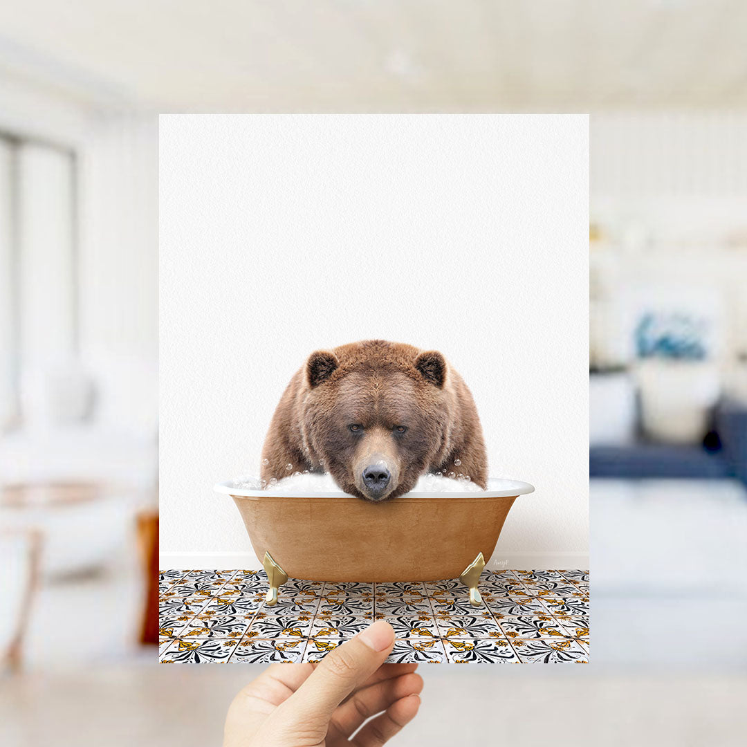A brown bear sitting in a bathtub filled with water, with a hand holding up the image to show it.