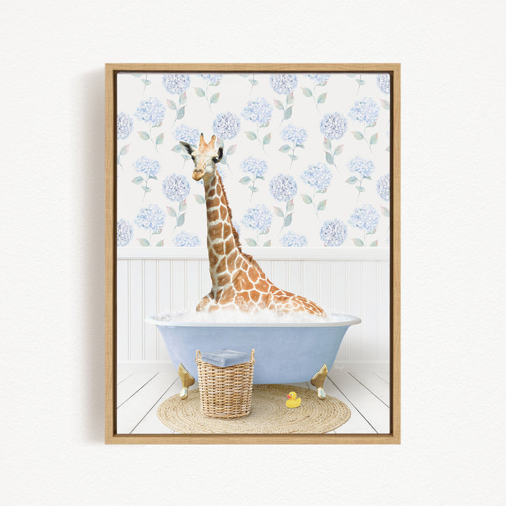 A giraffe is sitting in a blue bathtub filled with water, surrounded by a wicker basket and a yellow rubber duck.