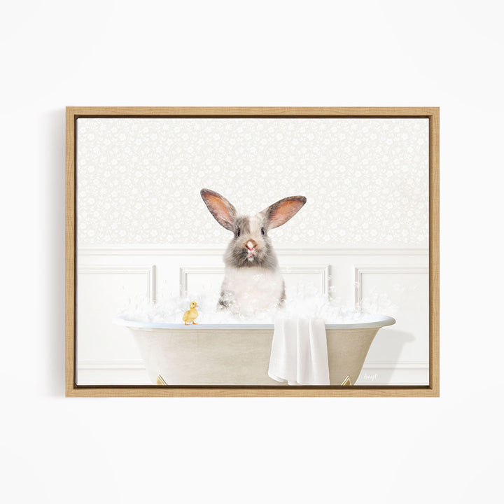A fluffy white rabbit sits in a bathtub filled with bubbles, accompanied by a yellow rubber duck.