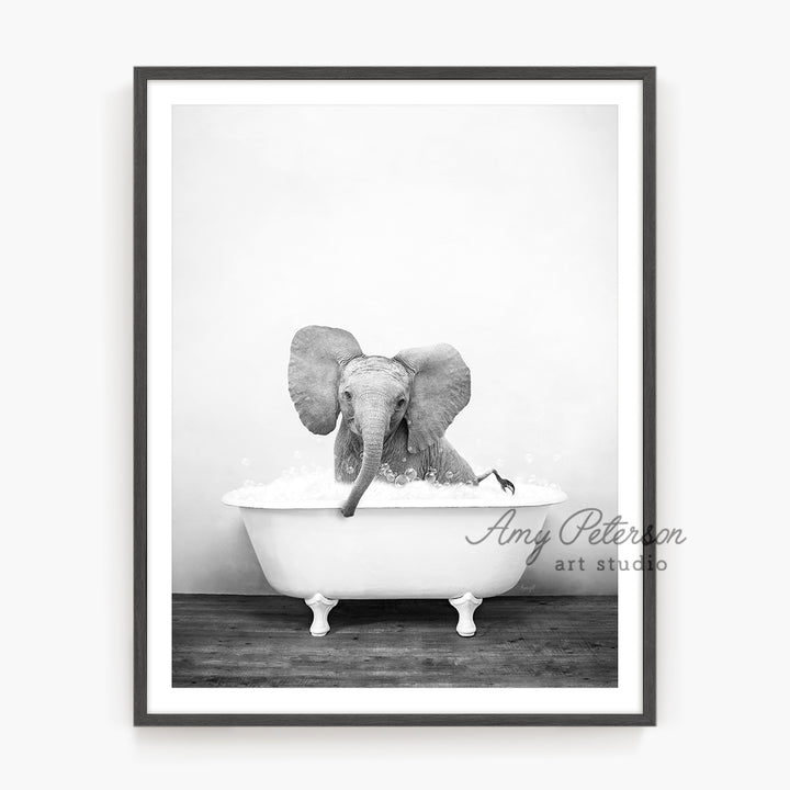 a black and white photo of an elephant in a bathtub