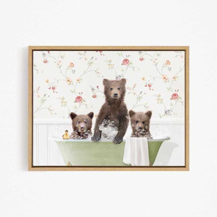 Three adorable brown bears sitting in a green bathtub, surrounded by a floral patterned wall.