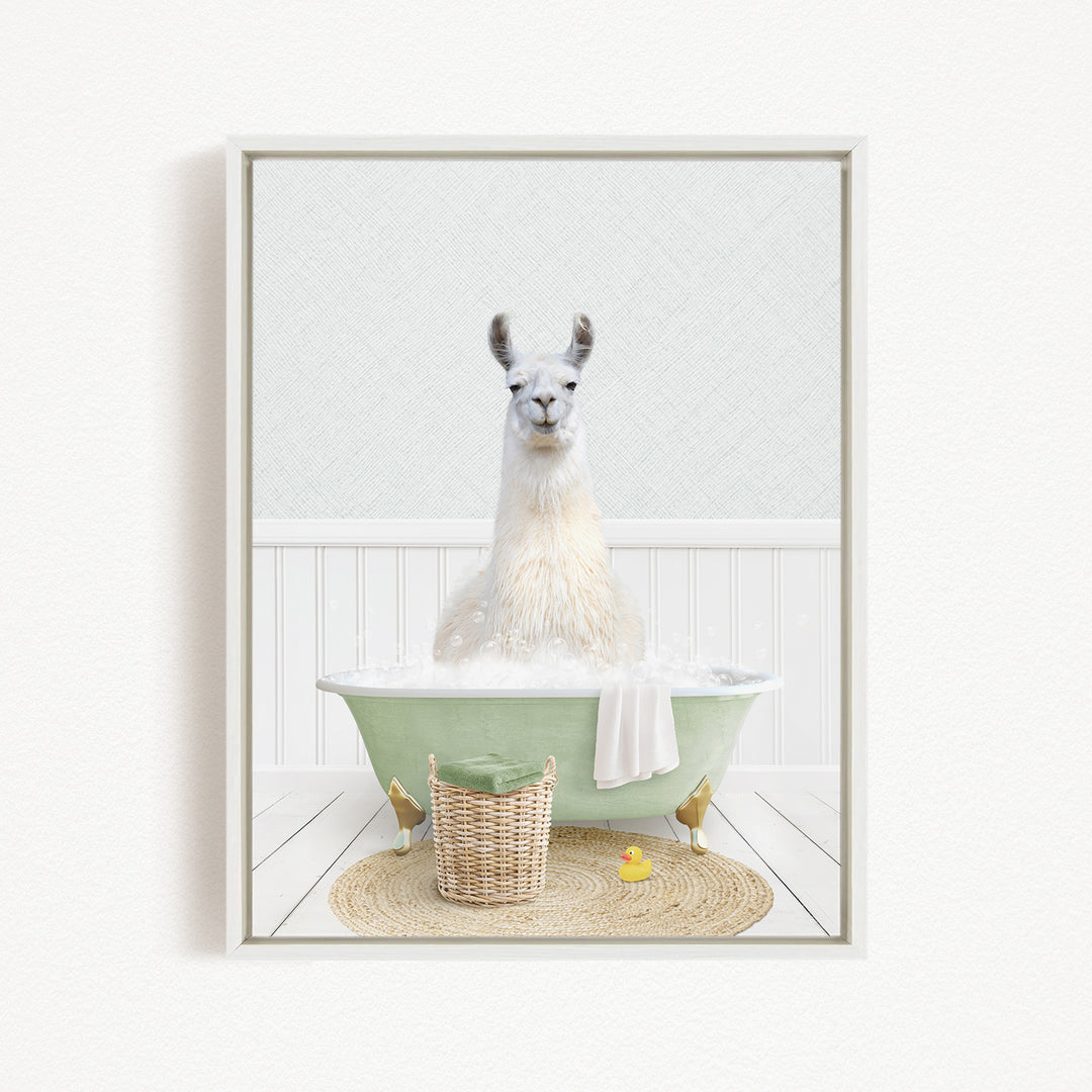 A white llama sitting in a green bathtub filled with bubbles, surrounded by a basket of toys and a yellow rubber duck.