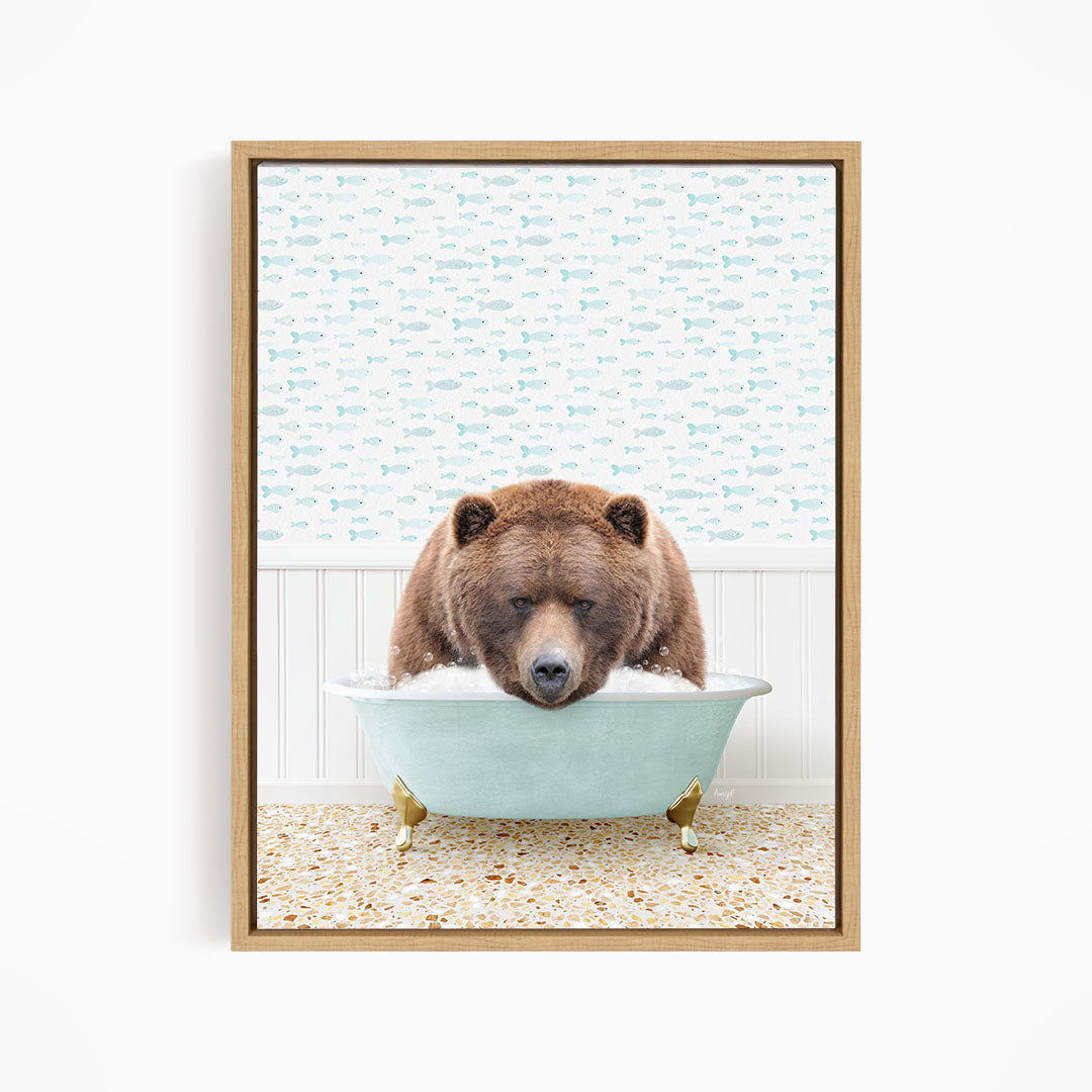 A brown bear is sitting in a light blue bathtub filled with water, surrounded by a pattern of fish.