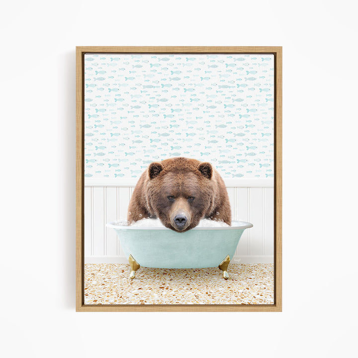 A brown bear is sitting in a light blue bathtub filled with water, surrounded by a pattern of fish.