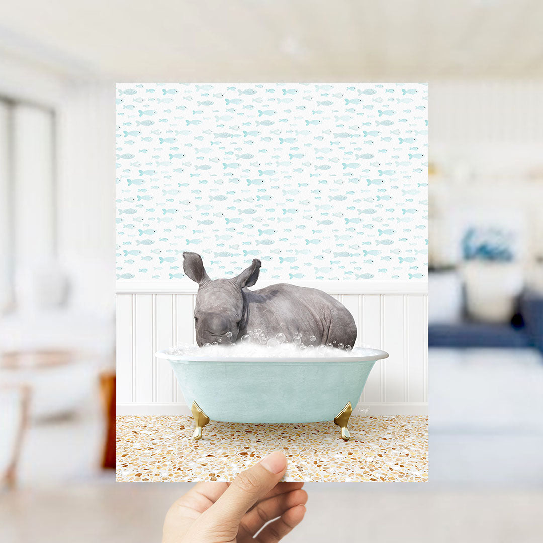 A rhinoceros is sitting in a bathtub filled with bubbles, surrounded by a pattern of fish.