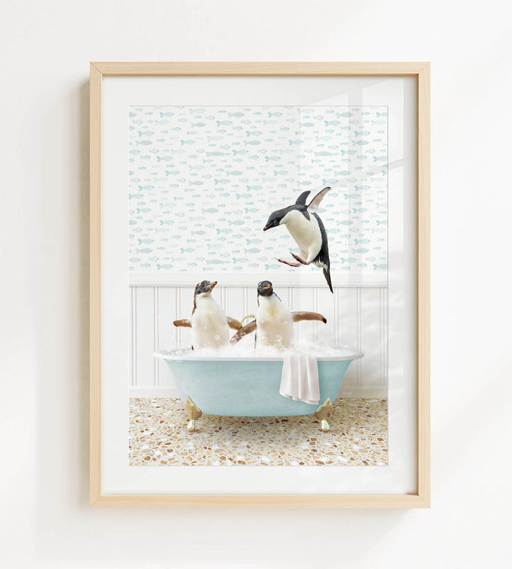 A framed image depicting two penguins sitting in a bathtub, with one penguin jumping out of the tub.