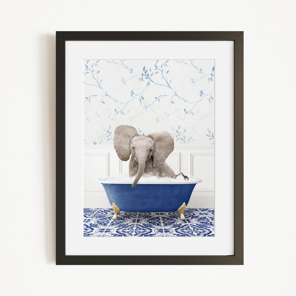 A gray elephant is sitting in a blue bathtub filled with water, surrounded by a blue and white patterned rug.