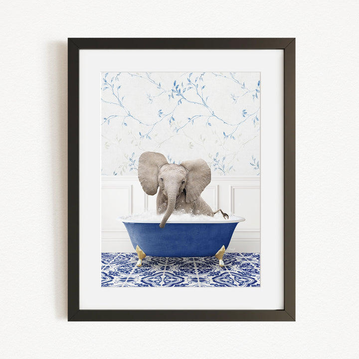 A gray elephant is sitting in a blue bathtub filled with water, surrounded by a blue and white patterned rug.