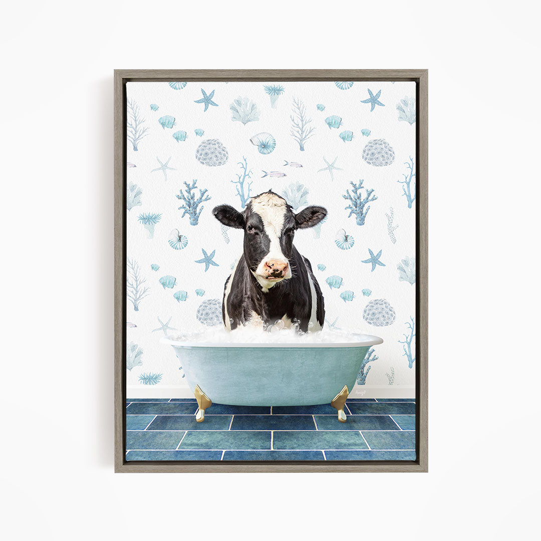 A black and white cow is sitting in a blue bathtub filled with water, surrounded by a pattern of seashells, starfish, and other marine life.