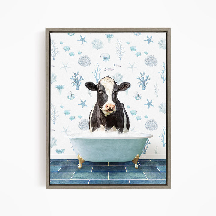 A black and white cow is sitting in a blue bathtub filled with water, surrounded by a pattern of seashells, starfish, and other marine life.
