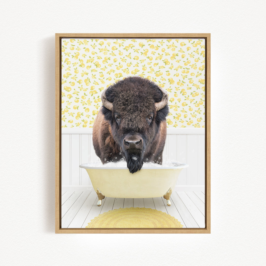 A buffalo is sitting in a bathtub filled with water, surrounded by a yellow floral pattern on the wall behind it.