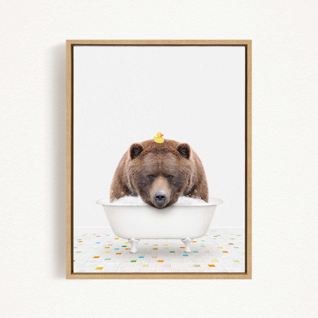 A brown bear is sitting in a white bathtub, with a yellow rubber duck perched on its head.