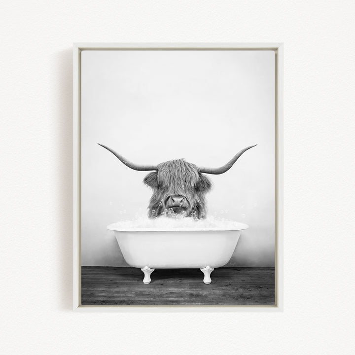 A black and white image of a long-haired animal, possibly a yak or a similar creature, sitting in a white bathtub and enjoying a bath.