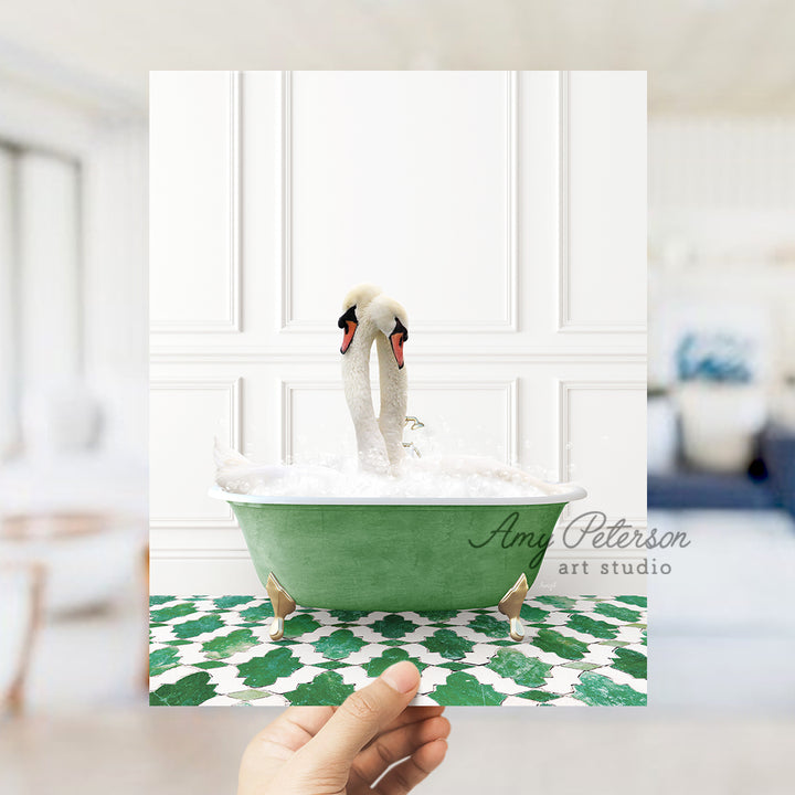 a person holding a card with a picture of two swans in a bathtub