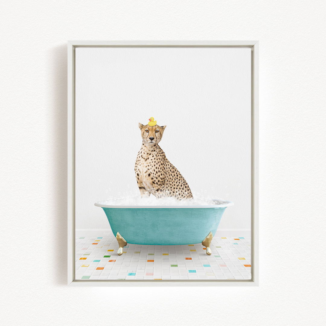 A cheetah sitting in a blue bathtub filled with bubbles, with a yellow rubber duck perched on its head.
