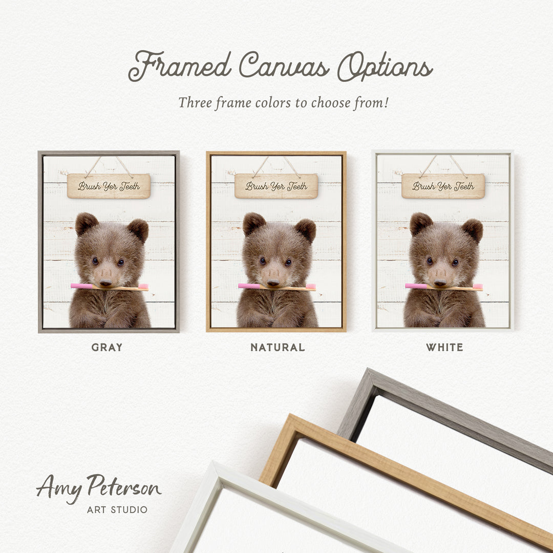 three framed canvas options featuring a teddy bear holding a toothbrush. The options include a gray frame, a natural frame, and a white frame.