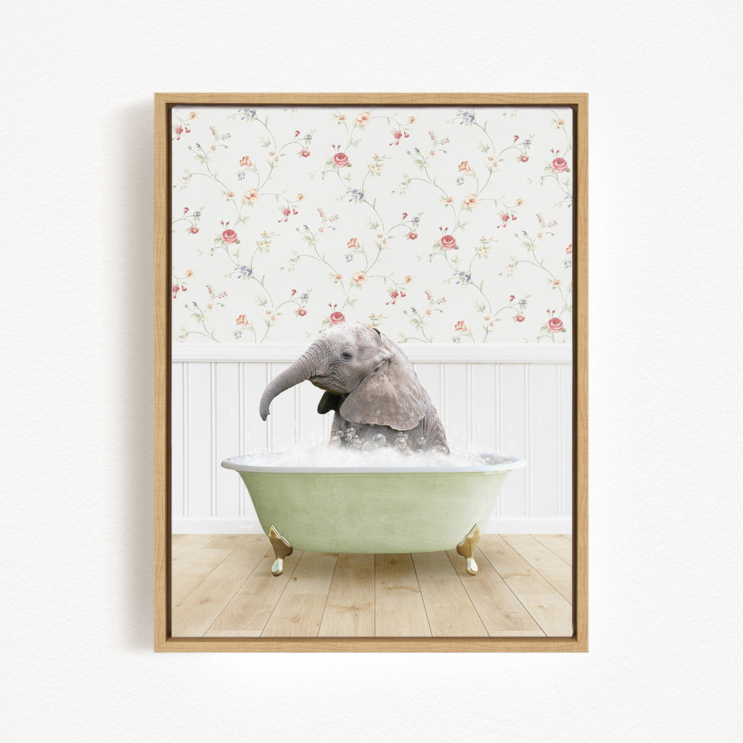 A baby elephant sitting in a green bathtub filled with water, surrounded by a floral wallpaper.