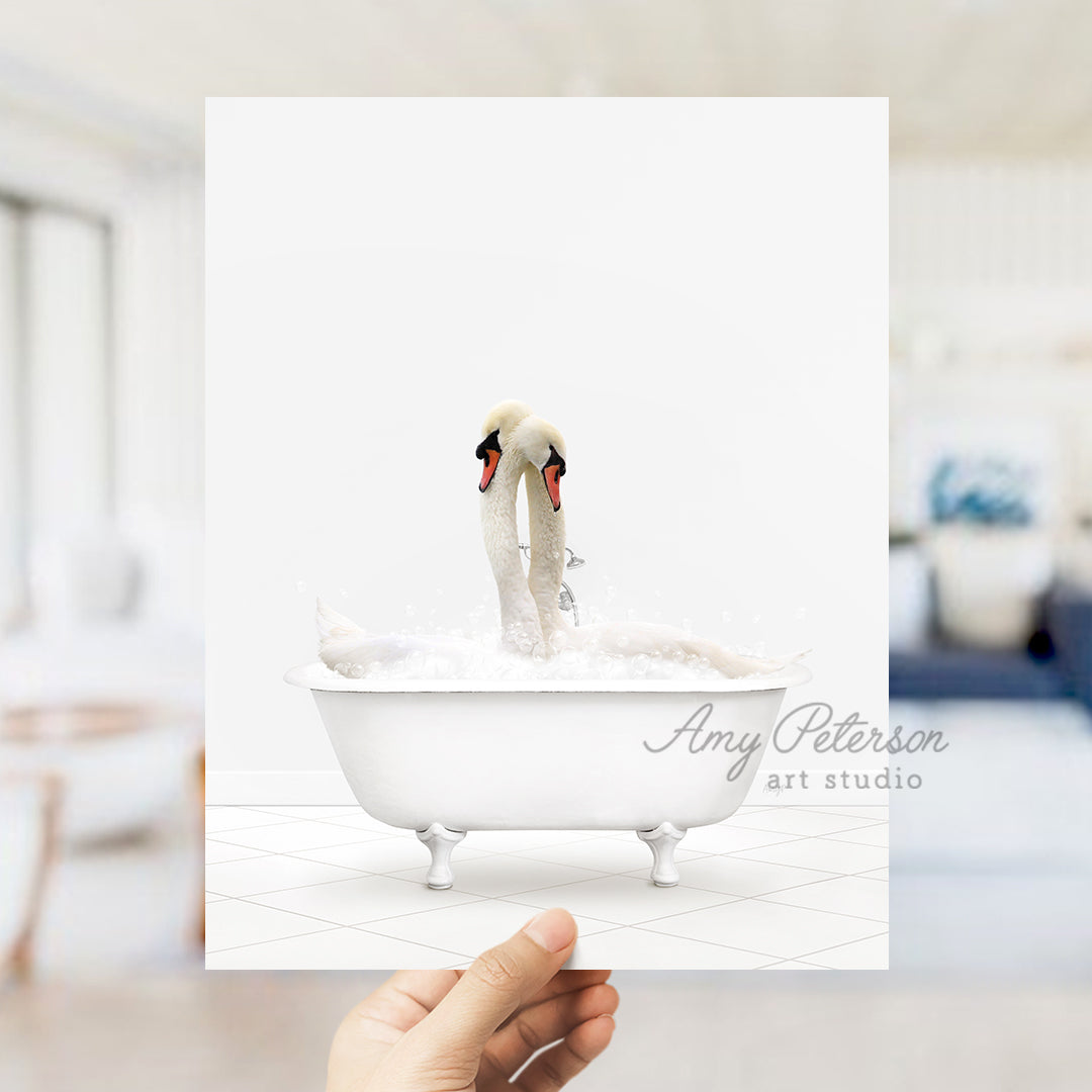 a person holding up a card with two swans in a bathtub