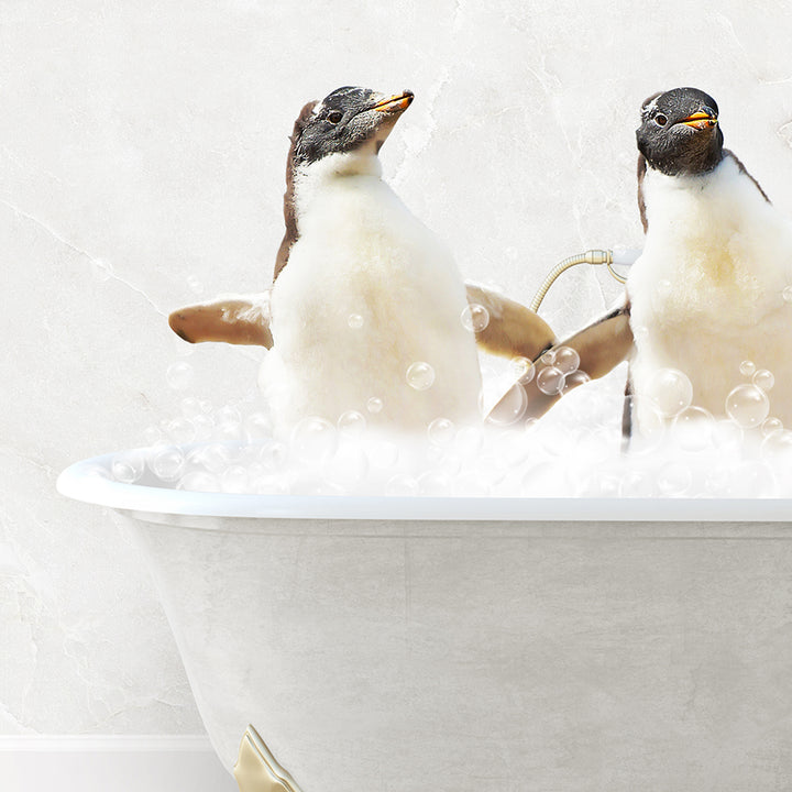 two penguins sitting in a bathtub with bubbles