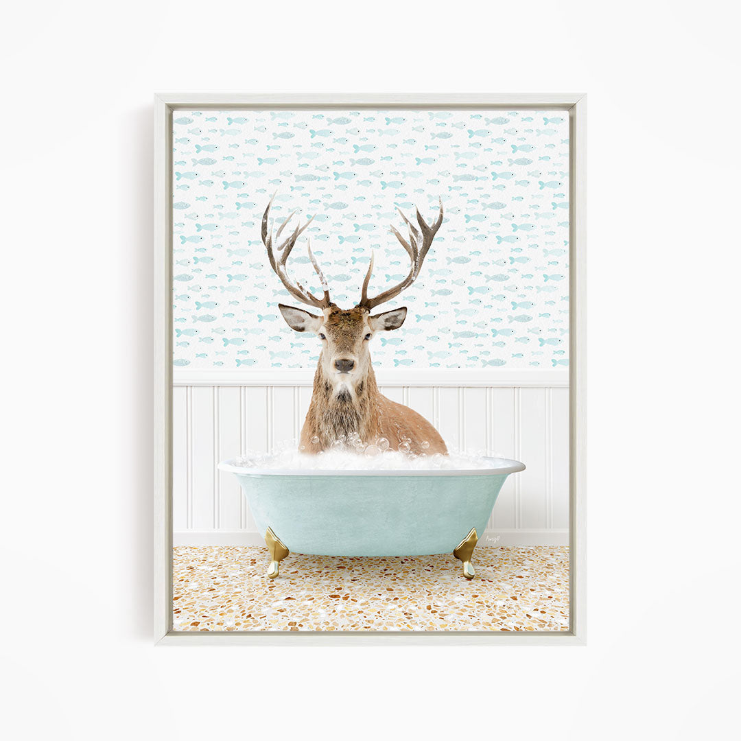 A deer with antlers is sitting in a light blue bathtub filled with bubbles, surrounded by a pattern of small fish.