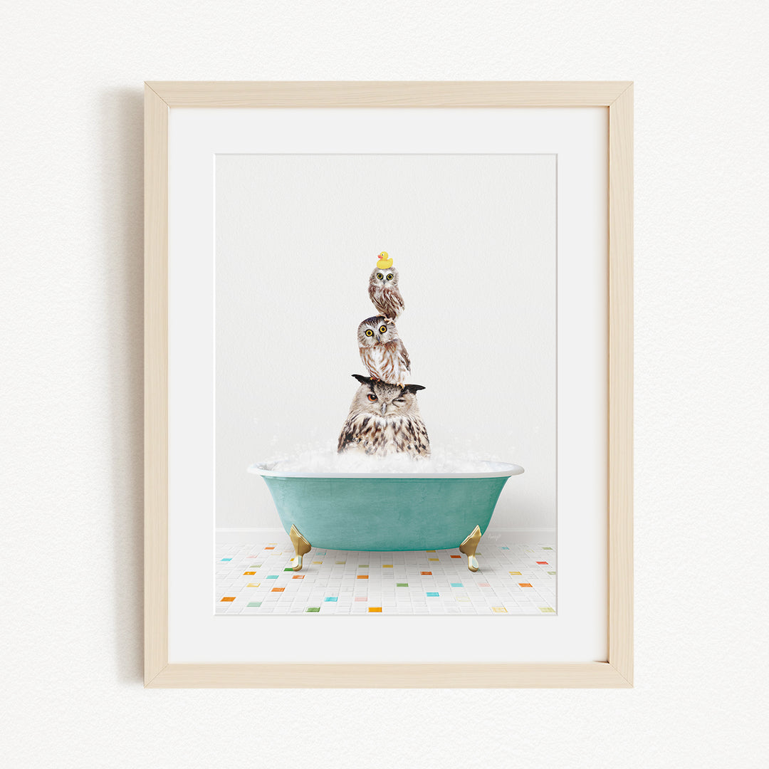 A framed image depicting a group of owls sitting in a bathtub filled with bubbles, creating a whimsical and playful scene.
