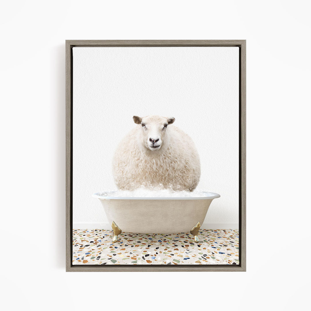 A fluffy white sheep sits in a white bathtub filled with bubbles, creating a whimsical and playful scene.