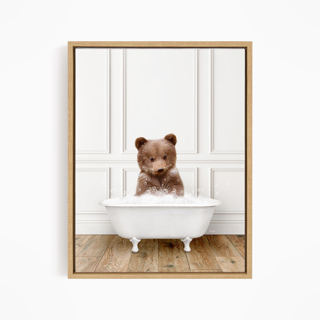 A brown bear sitting in a white bathtub filled with water, looking at the camera.