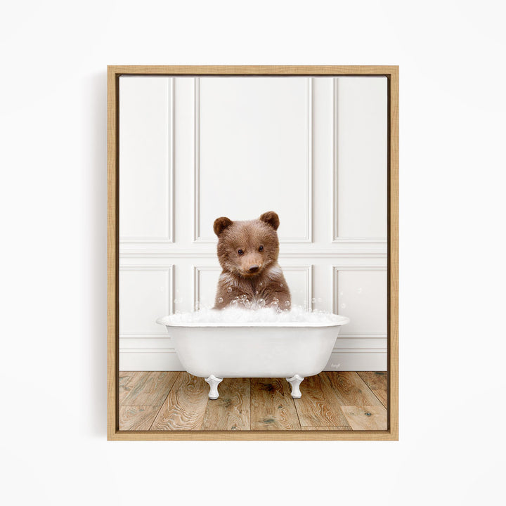 A brown bear sitting in a white bathtub filled with water, looking at the camera.