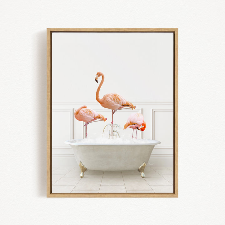 A framed image depicting three pink flamingos standing in a white bathtub filled with water.