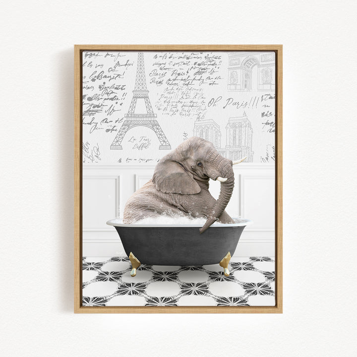 A gray elephant is sitting in a black bathtub, surrounded by a black and white tiled floor and a wall with various inscriptions and drawings.