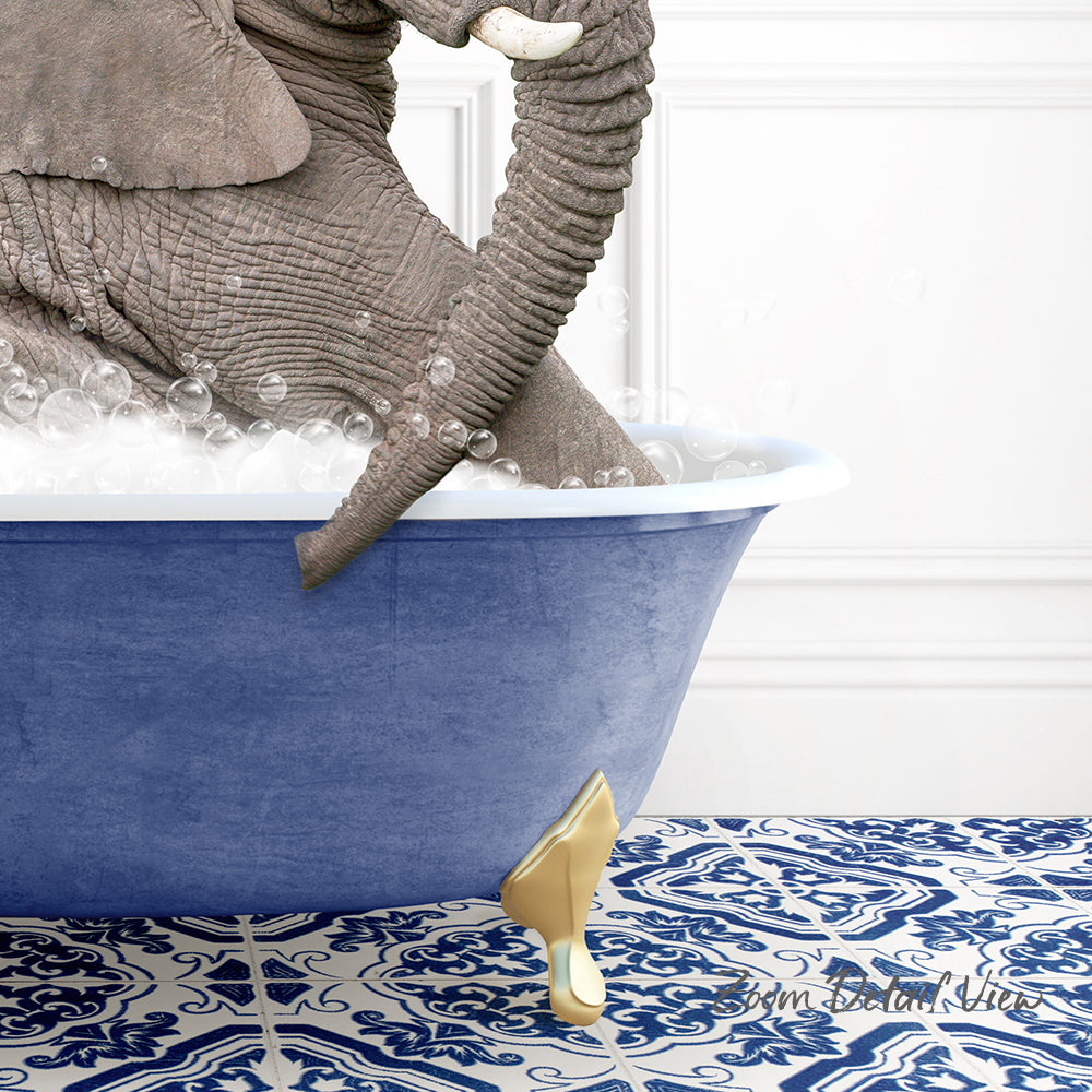 A large elephant is sitting in a blue bathtub filled with bubbles, with its trunk curled around the edge of the tub.