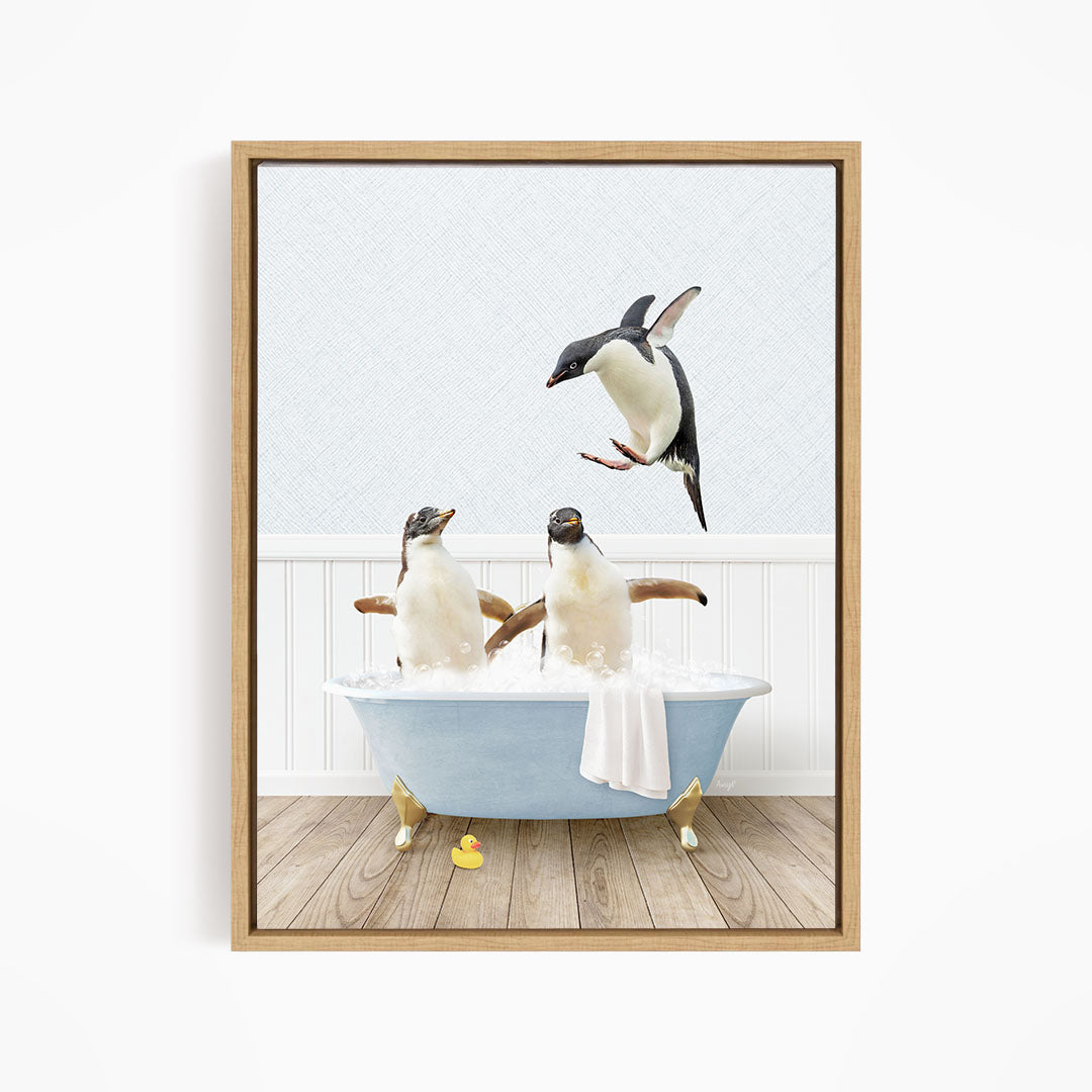 A framed image depicting two penguins sitting in a bathtub, with one penguin flying towards the other penguin.