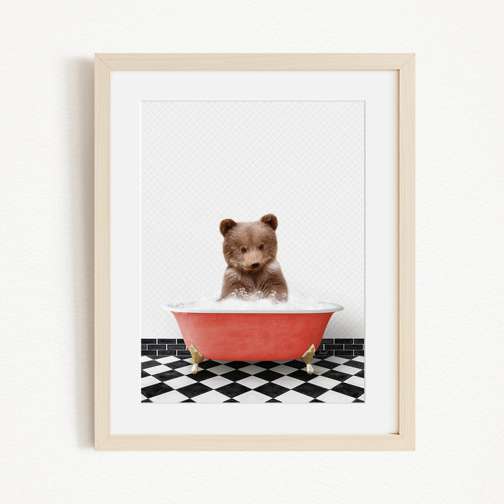 A small brown bear sitting in a red bathtub filled with water, surrounded by a black and white checkered floor.