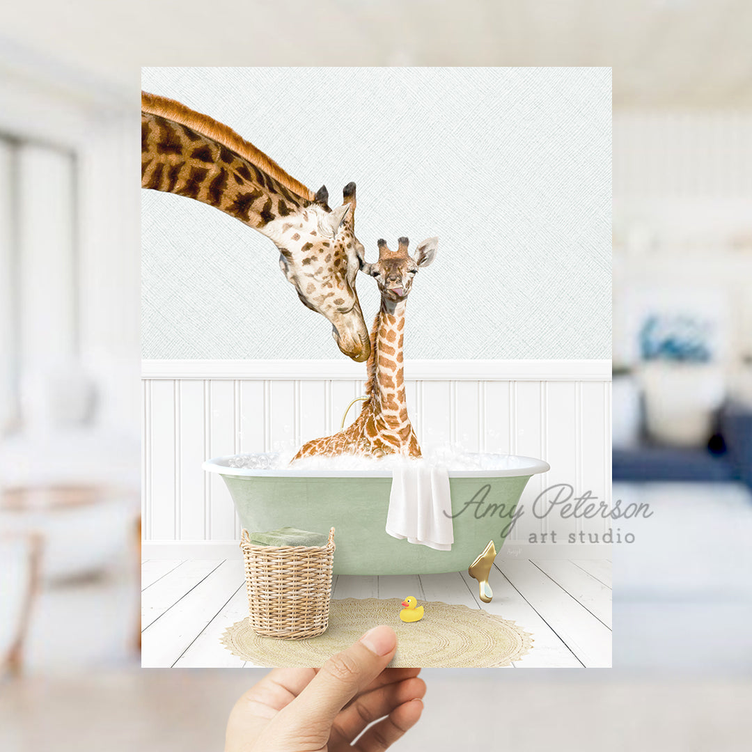 a person holding a card with a giraffe and a baby giraffe