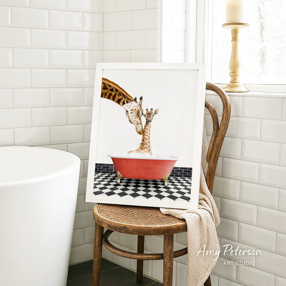 A framed image of a giraffe and a baby giraffe sitting in a red bathtub, with a black and white checkered floor in the background.