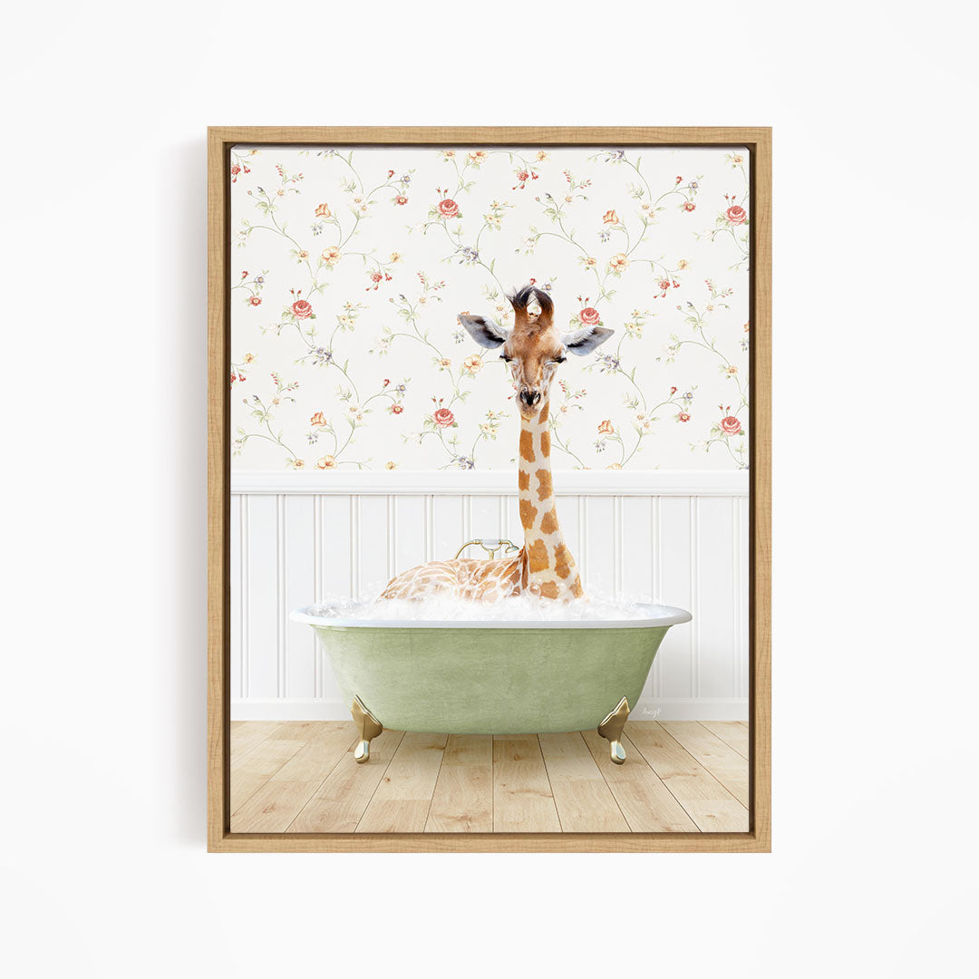 A giraffe is sitting in a green bathtub, surrounded by a floral wallpaper.
