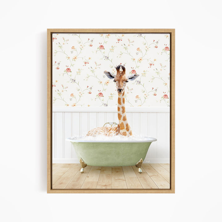A giraffe is sitting in a green bathtub, surrounded by a floral wallpaper.