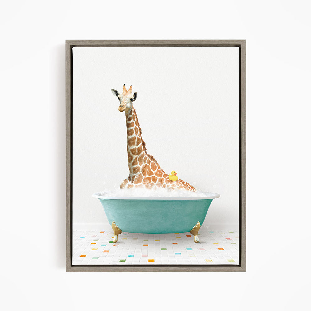 A giraffe is sitting in a blue bathtub filled with bubbles, with a yellow rubber duck floating on the water.
