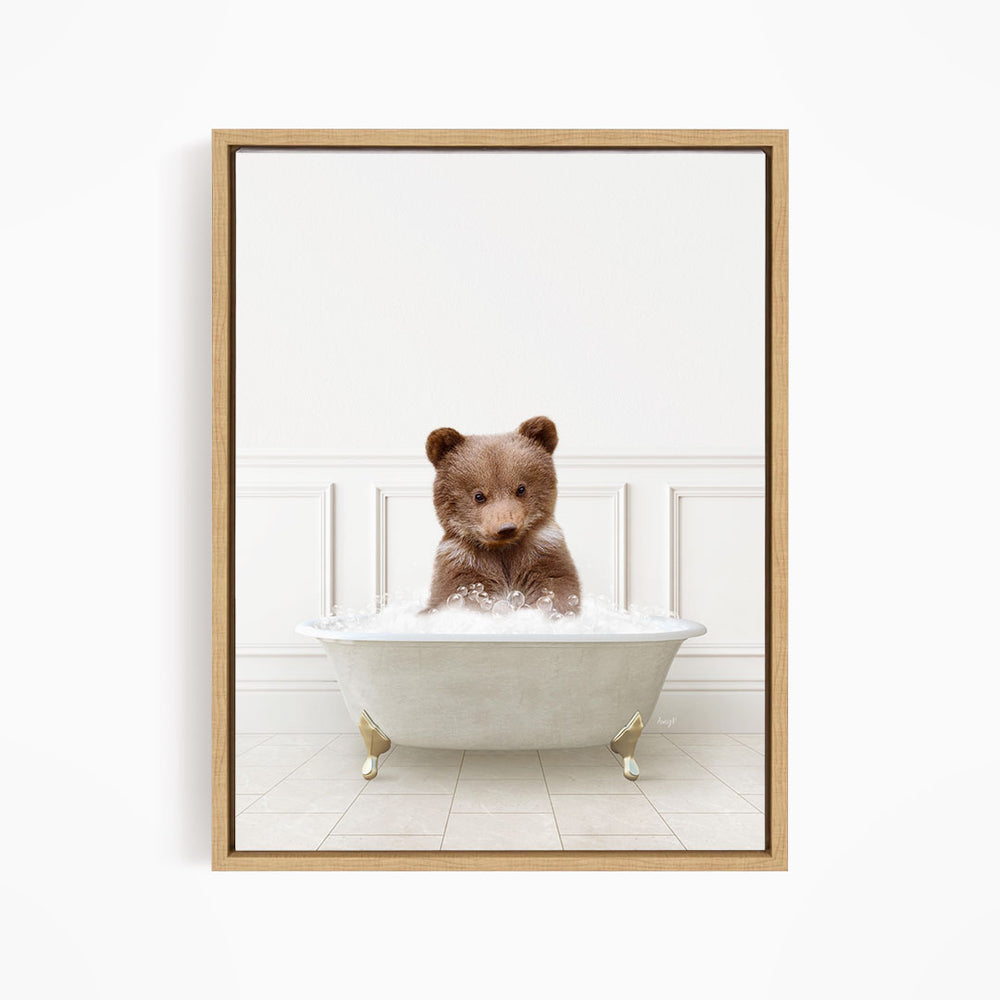 A brown bear sitting in a white bathtub filled with water, looking directly at the camera.