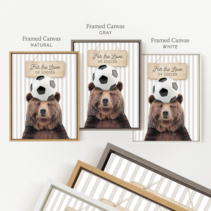 a framed canvas with a bear holding a soccer ball on its head.
