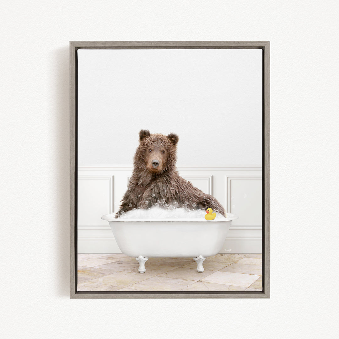 A brown bear sitting in a white bathtub filled with bubbles, with a rubber duck floating in the water.