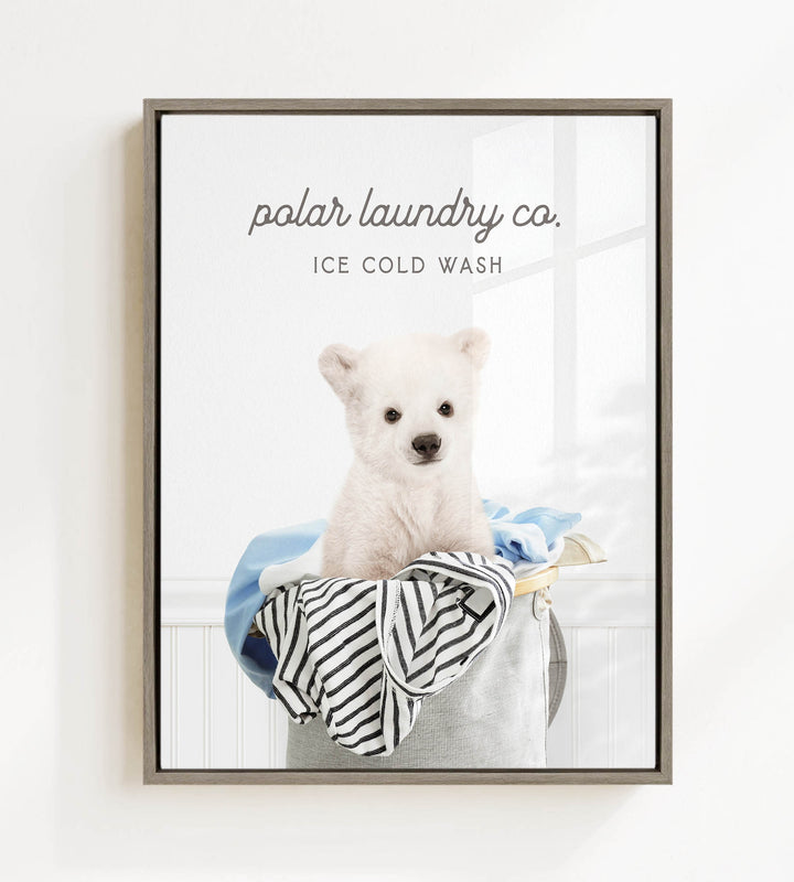 A white polar bear sitting in a laundry basket filled with clothes, with the text "ice cold wash" above the image.