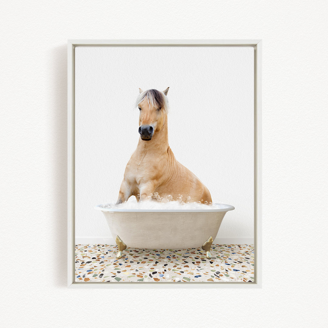 A light brown horse is sitting in a white bathtub filled with water, creating a whimsical and playful scene.