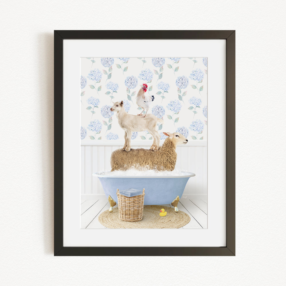 A framed image depicting a sheep standing on a tub filled with water, with a chicken perched on top of the sheep, and a basket of rubber ducks nearby.