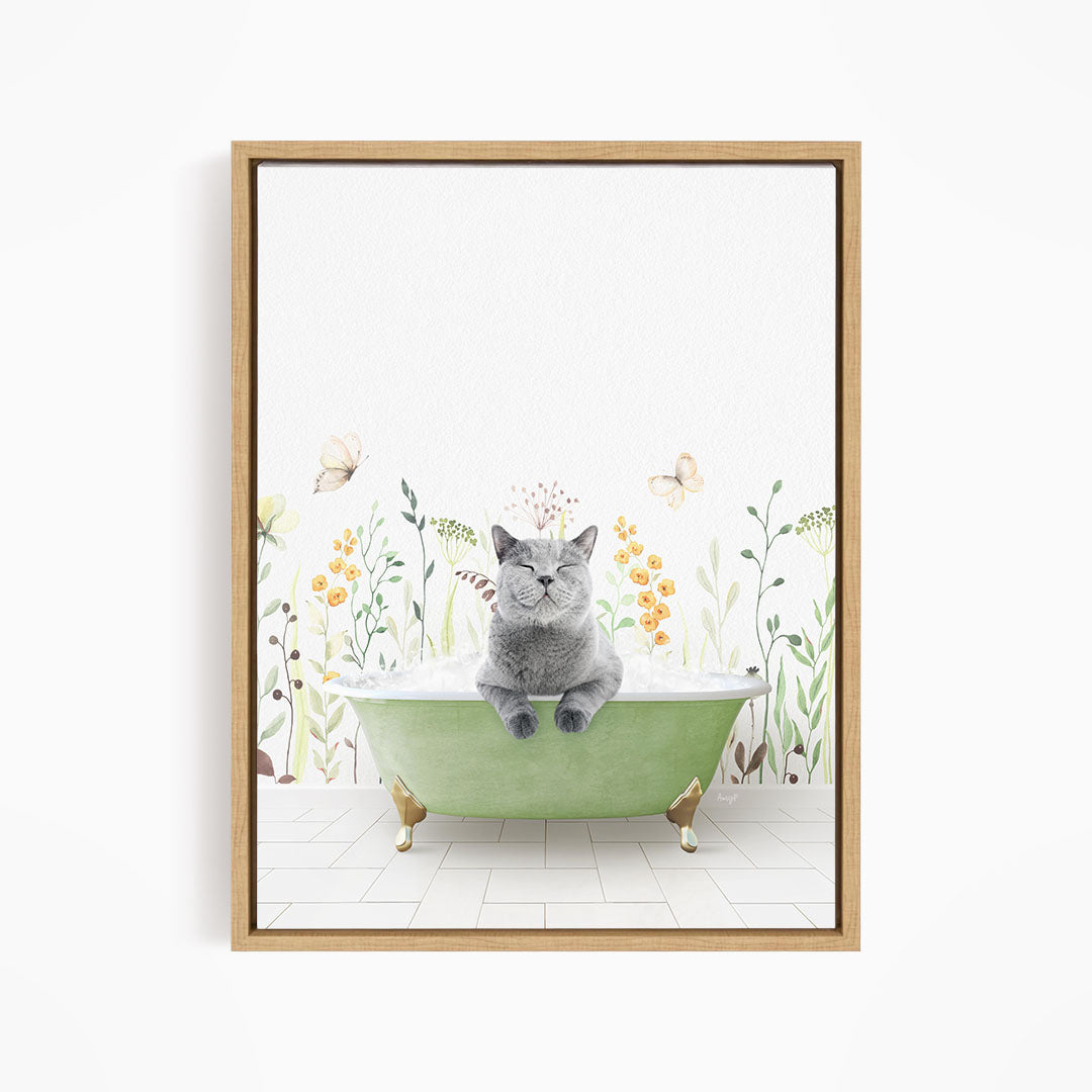 A gray cat sitting in a green bathtub filled with water, surrounded by flowers and butterflies.