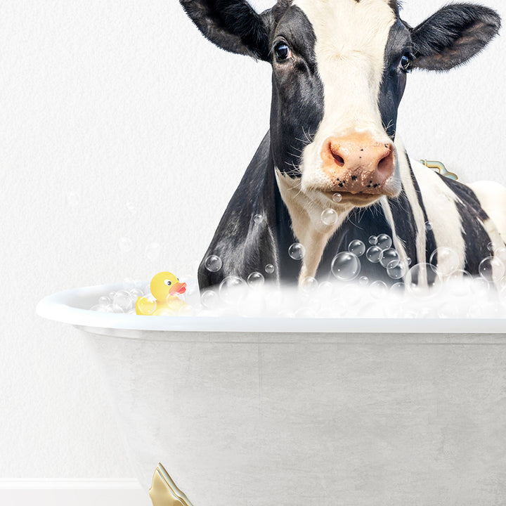 a black and white cow in a bathtub with bubbles