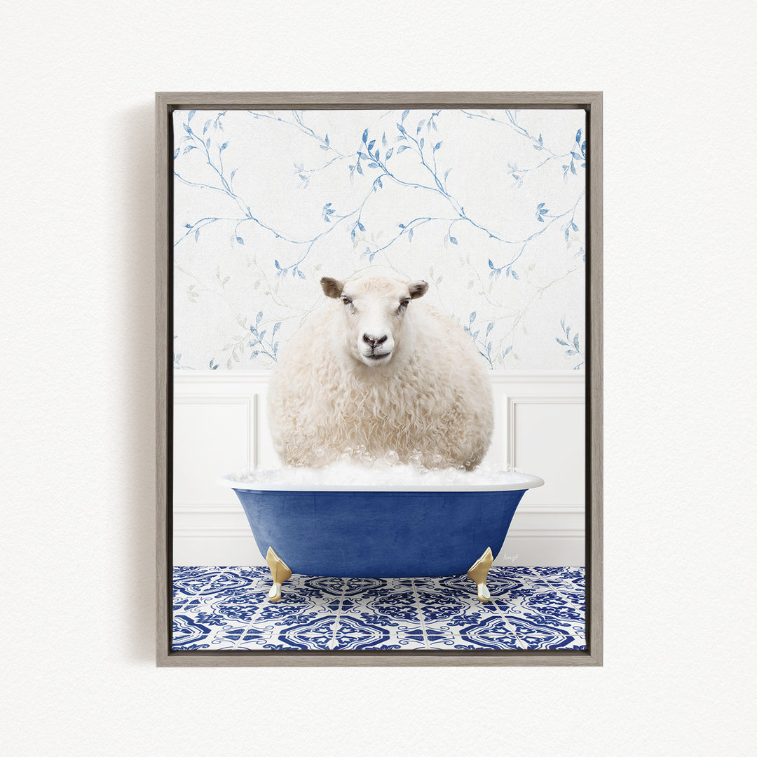 A fluffy white sheep sits in a blue bathtub, surrounded by a blue and white patterned tile floor.