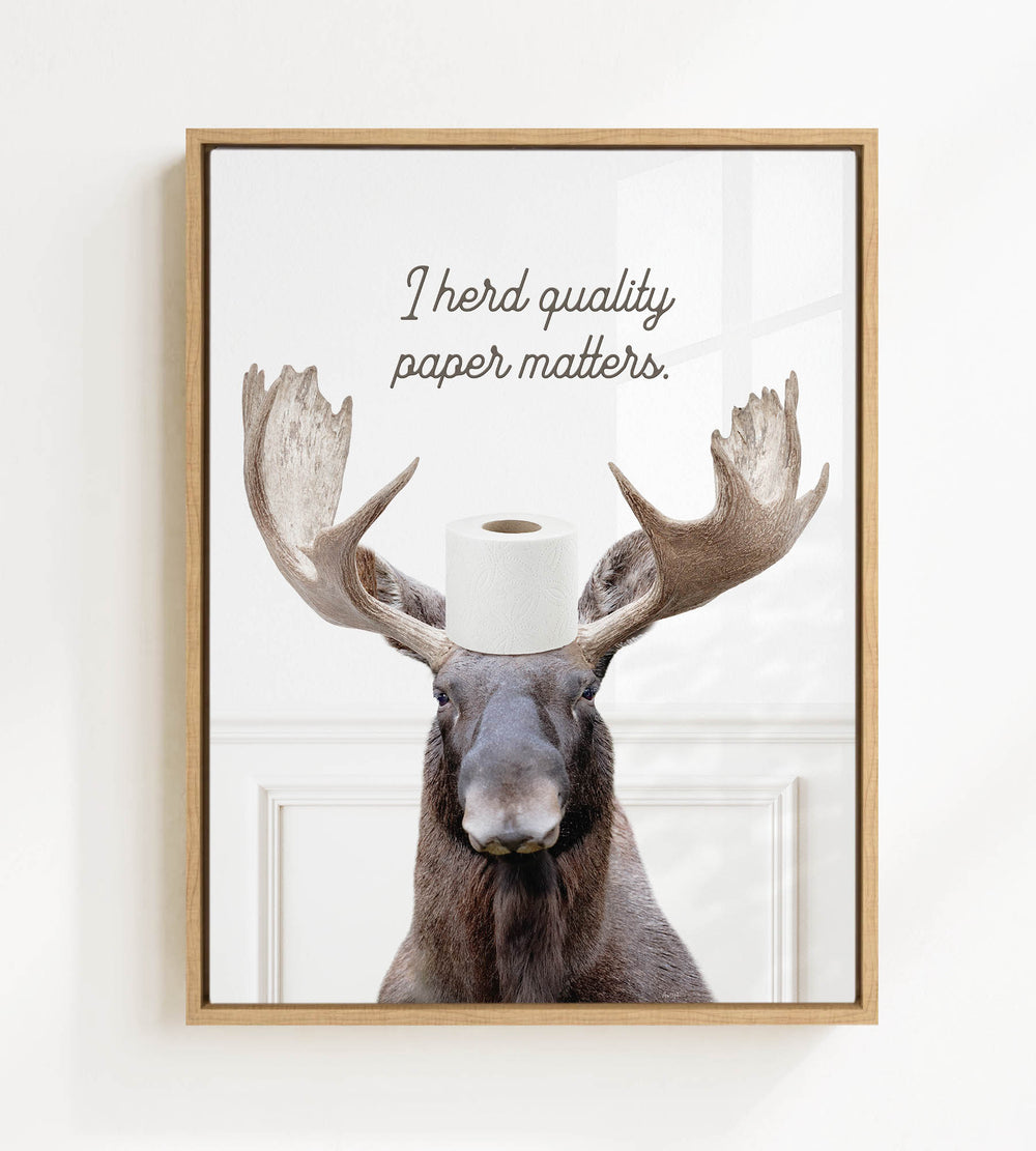 A moose wearing a roll of toilet paper on its head, with the text "I herd quality paper matters" above it.