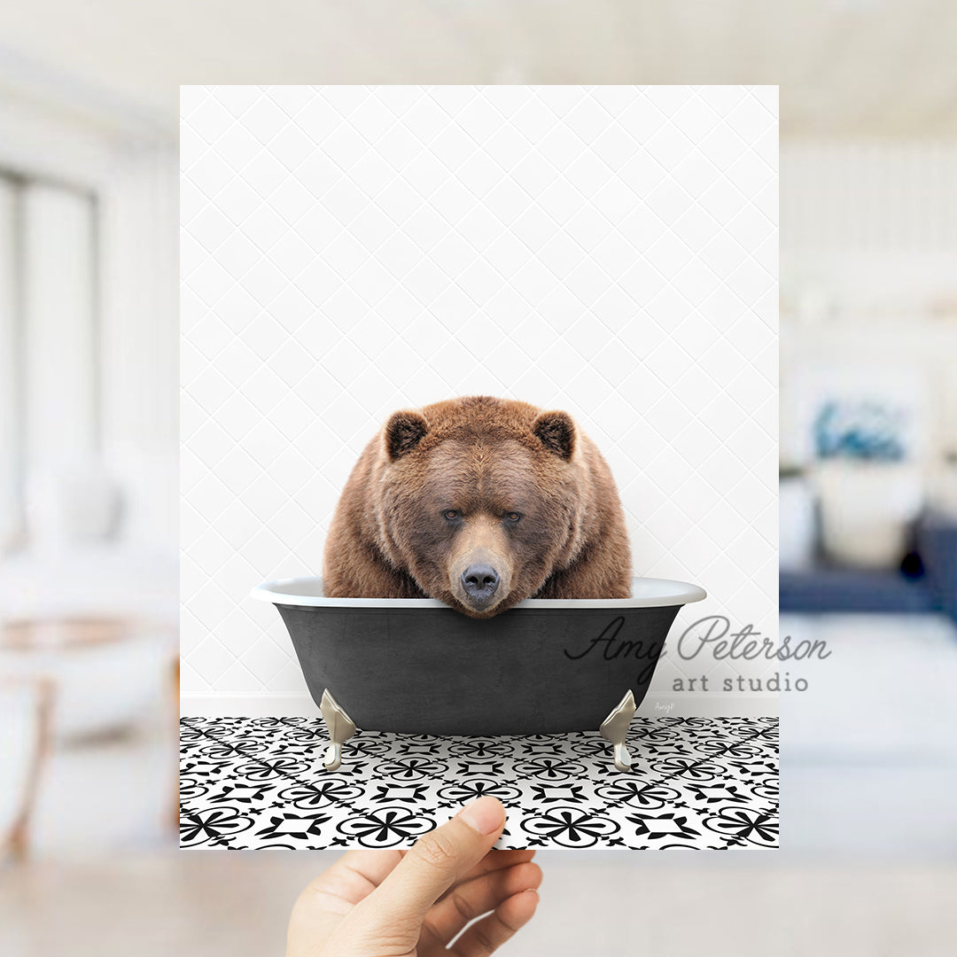 a person holding up a picture of a bear in a bathtub